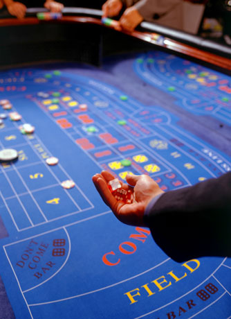 Craps table hand with dices